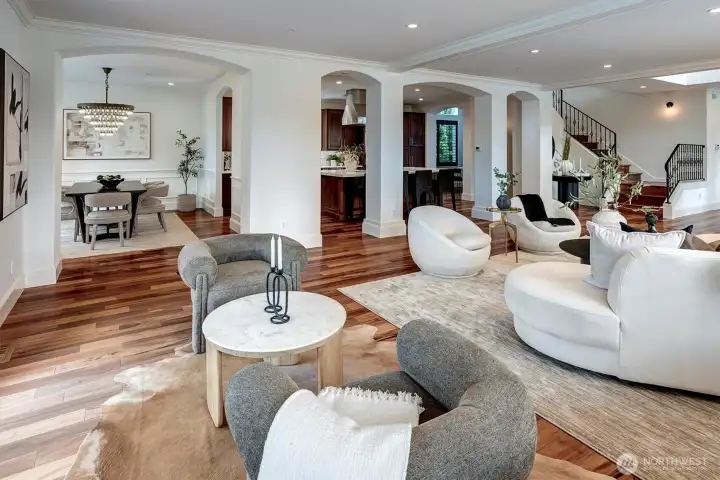 Luxury kitchen and dining room are framed by elegant architectural columns that define the spaces while preserving the effortless flow.