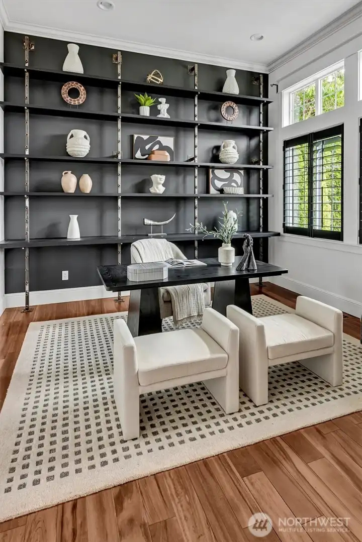 Striking salvaged metal shelving and soaring 11-foot ceilings highlight the main level bedroom! Perfect for an office or studio and complete with an en suite bath!