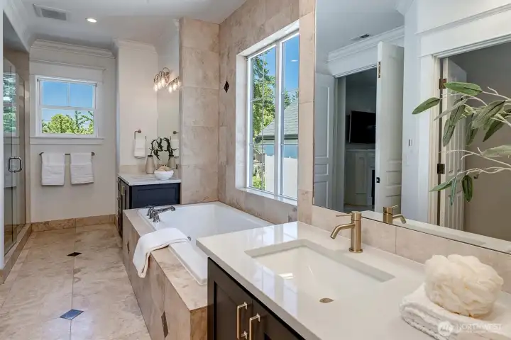 Indulge in the spa-inspired 5-piece en suite designed for ultimate relaxation. Step onto the heated floors and enjoy the beautiful designer quartz counters accented by luxe brass fixtures elevating the space with timeless sophistication.