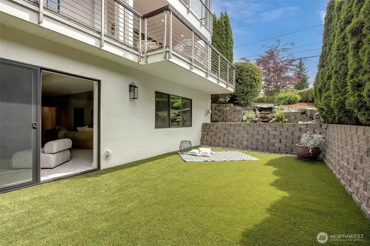Seamlessly extending from the lower level, this private turf area offers a tranquil escape with effortless maintenance!
