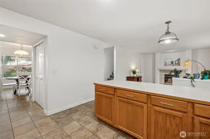 Family room with gas fireplace adjacent to large kitchen