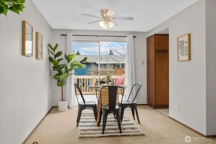 Dining area with sliding door access to deck and backyard.