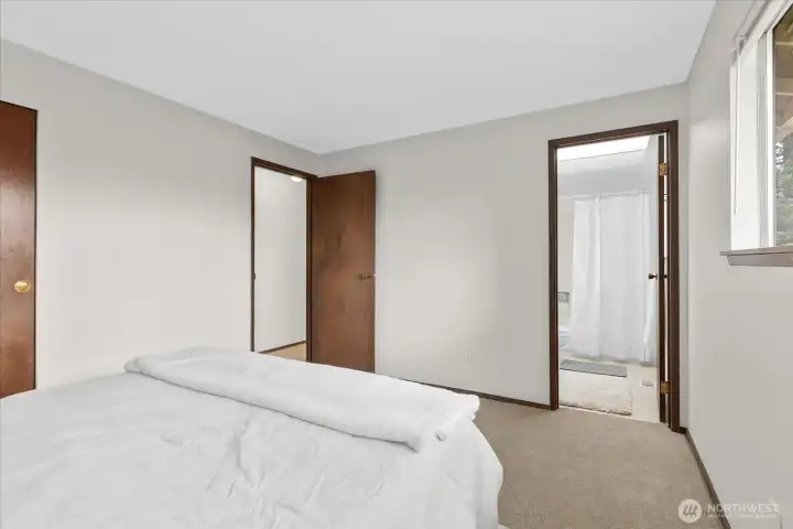 Primary bedroom view showing room entrance and attached full bathroom.
