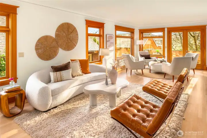 Light-filled living room with rich wood windows and outdoor access