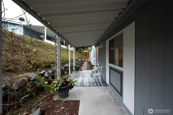 Gorgeous landscaping, rock patio and covered deck.
