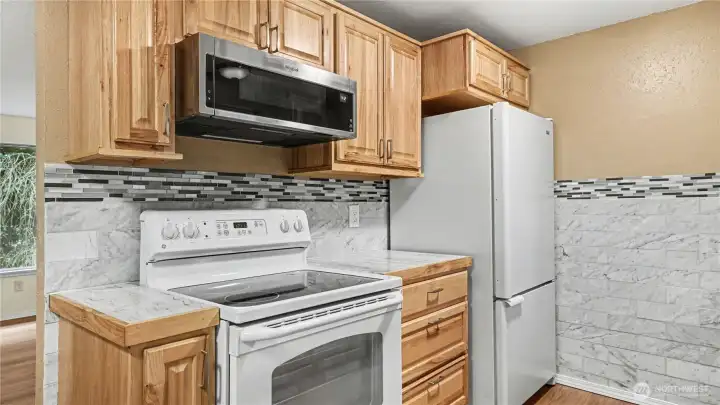 Kitchen features plenty of cabinet storage and ample counterspace.