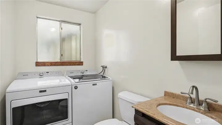 Downstairs half bathroom with laundry.