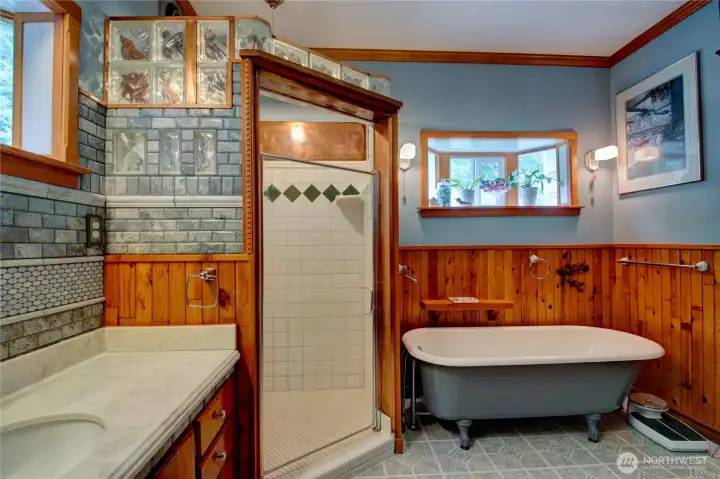 Clawfoot tub and shower with gorgeous tile and copper accents.