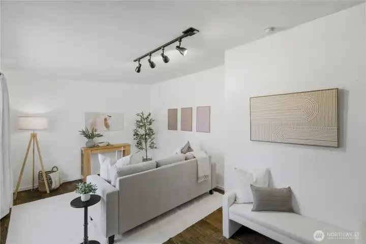 Upon stepping in, you are greeted with a living room with lots of natural light and vaulted ceilings