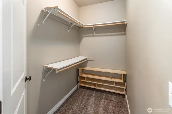 Primary walk in closet- bigger than it appears!