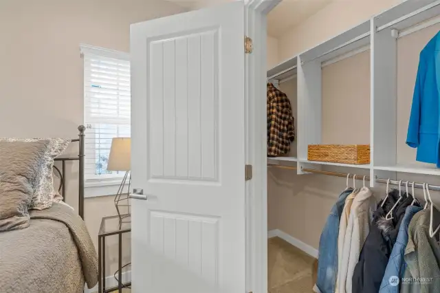 The main floor bedroom offers a spacious walk-in closet with built-in shelves for organization.