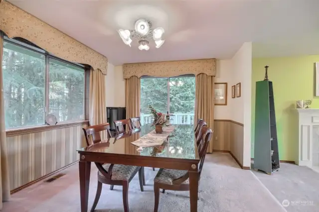 Dining room has custom drapery and tasteful choice of chandlier