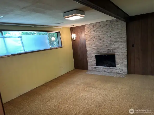 Additional downstairs living room w/ wood burning fireplace