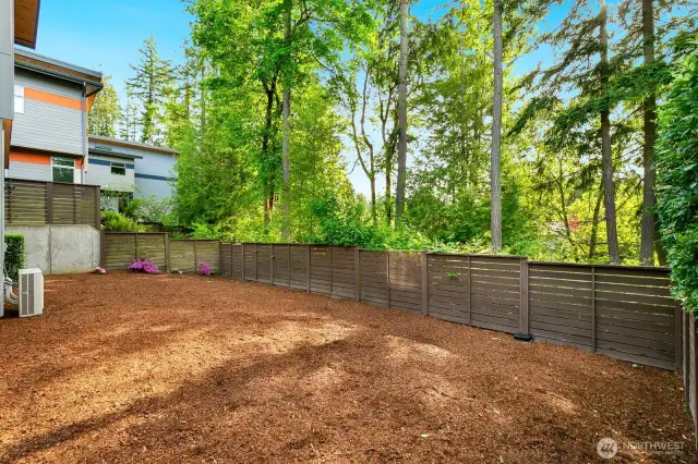 Flat, sunny but private by the greenbelt. Best backyard in the development!