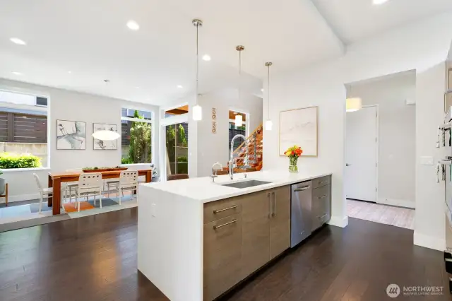 To the right, a beautiful kitchen opens to a large formal dining room