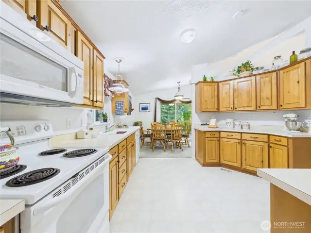 White appliances and wood cabinets presents this beauty in a classically stylish manner.