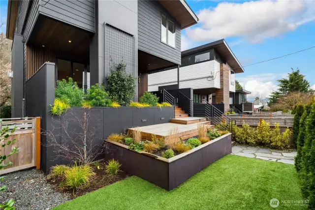 Local architect redesigned this space to allow secondary seating and improved natural flow.Brazilian hardwood decking.Drip irrigation. Planting beds clad with steel.