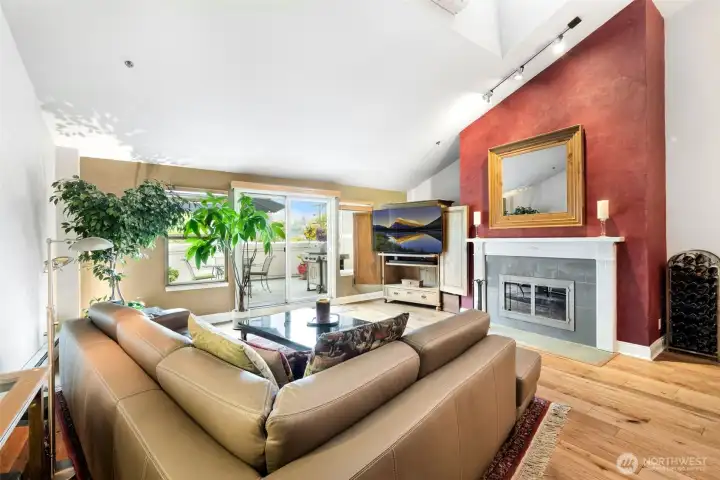 Large living room with high ceilings and wood burning fireplace!