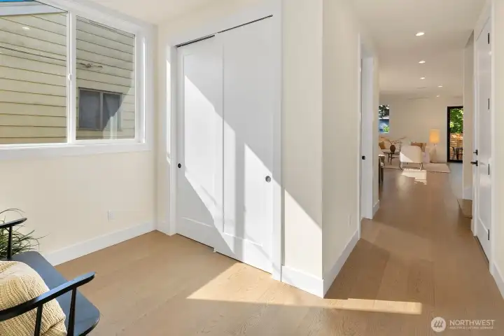 The entry access the main living area of the home. As you enter, there's extra space and a storage closet.