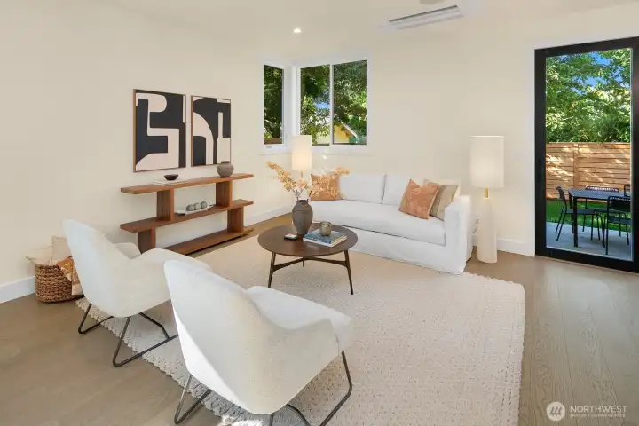 The living room sits just off the kitchen and dininag areas. In this photo, to the right is the sliding wall that opens out to the fully fenced level backyard area and patio.