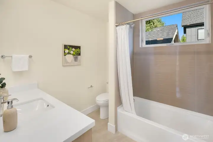 The 2 additional bedrooms on the second level of the home share this full bath.