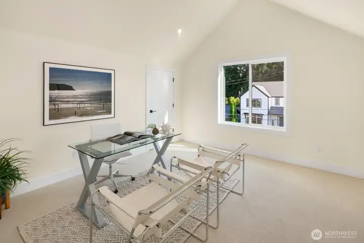 This is a 4th bedroom on the top level of the home. It is staged here as an office. there are two long closets on either side of the room for tons of storage space.