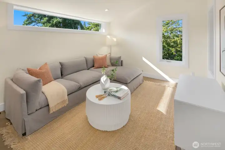 The top level of the home has a vaulted family room area with access to a covered deck.