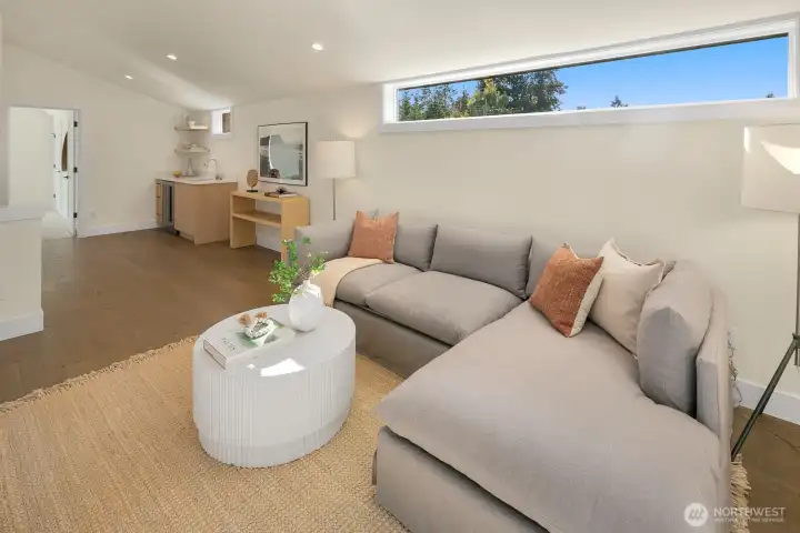 The family room on the top level of the home has a wetbar and access to a covered private deck area.