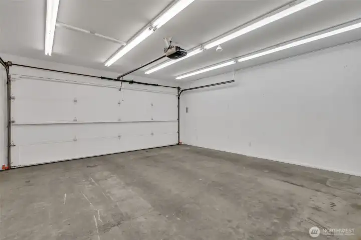 Well lit, attached two car garage with storage