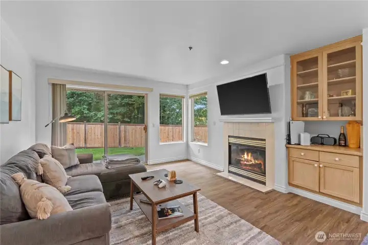 Living area flows to a patio and grassy space - ideal for pets and outdoor lounging.