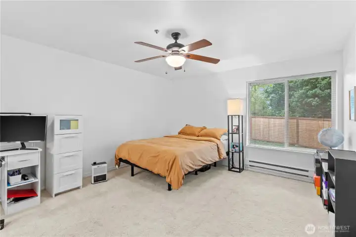 Ceiling fan in primary bedroom keeps you cool in the summer.