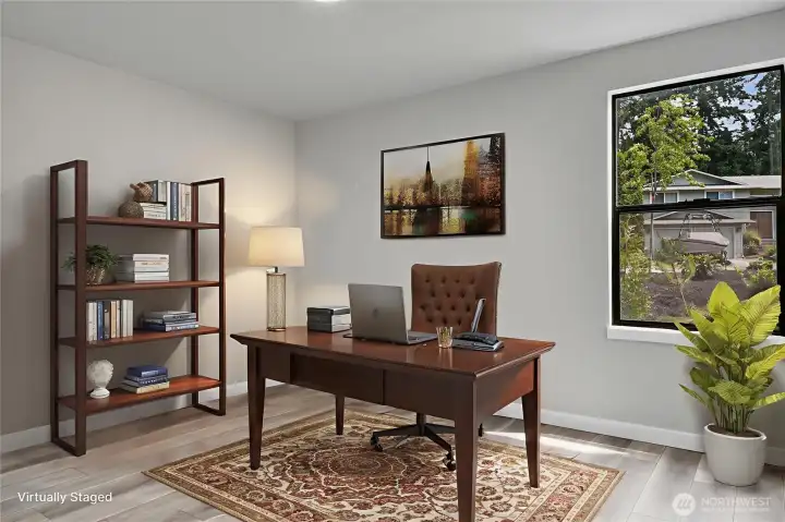 Main floor office with the flexibility to serve as a fourth bedroom. Virtually staged.
