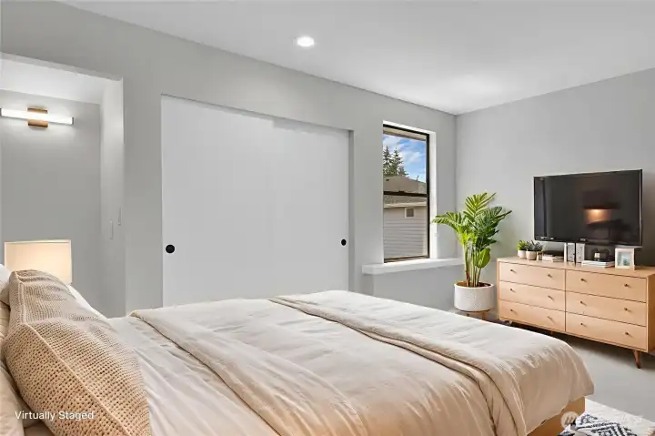 Second bedroom on the upper level with a niche perfect for a desk or vanity. Virtually staged.