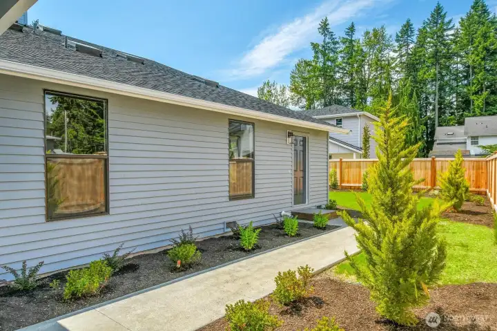 Private ADU entrance located on the side of the home, accessible through the front gate.