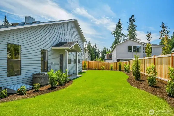 The expansive, fully fenced and thoughtfully landscaped backyard offers a serene outdoor oasis.