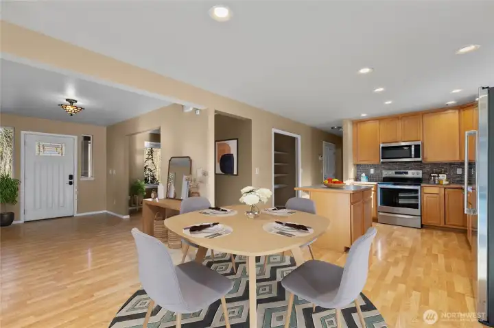 Kitchen with office/den down hallway straight ahead, entry to left, family room behind.