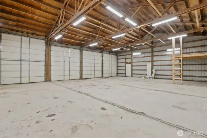 Four large shop doors: three 11'9"-tall × 11'-wide doors & one oversized 13'3"-tall × 10'-wide door.