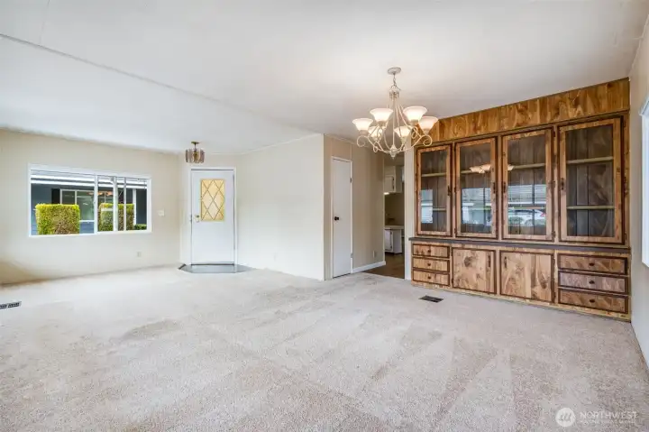 The dining area is open to the living room with a hallway to the rest of the home.
