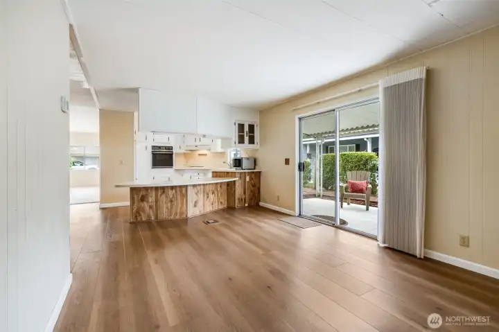 A large family room is adjacent to the kitchen and has a large door out to the covered patio.