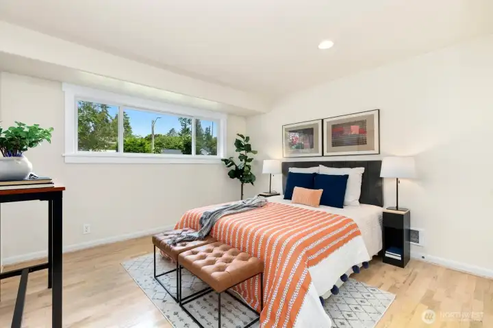 Spacious primary bedroom which captures warm western light.