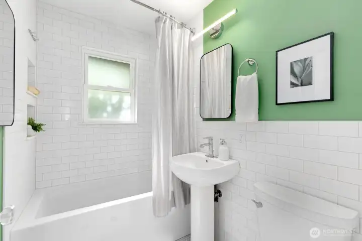 Fully renovated bathroom showcases both style and function.