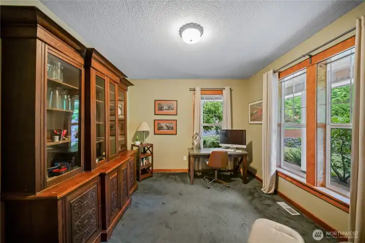 This handsome main floor office offers views to the front porch and yard. Handsome wood-wrapped windows offer plenty of light This handsome main floor office offers views to the front porch and yard. Handsome wood-wrapped windows offer plenty of light