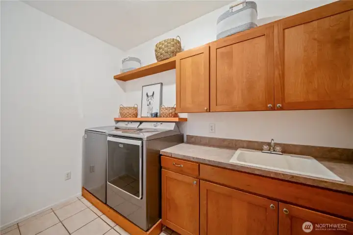 Main level laundry room with generous cabinet and counter space, laundry sink Main level laundry room with generous cabinet and counter space, laundry sink