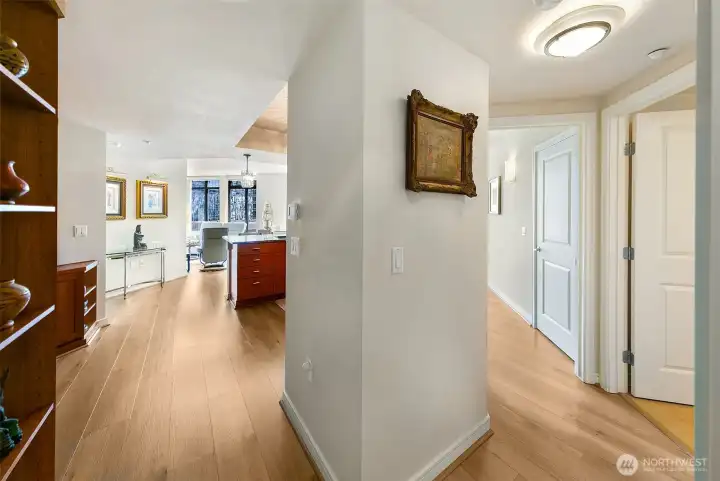 wide plank new hardwoods, beautiful entry with coat closet upon arrive - to the right is guest bath and 2nd bed/flex space - primary is on opposite side of with se views and partial lake union