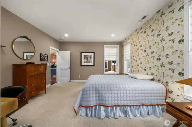 Spacious primary bedroom with upgraded carpet and custom shades.