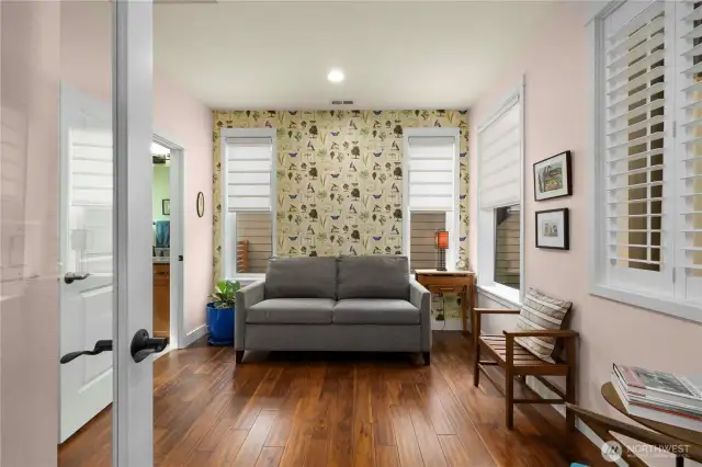 Versatile guest suite with French doors, plantation shutters, custom window shades and gleaming Engineered hardwoods.