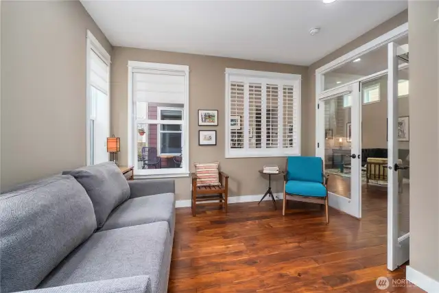 Versatile guest suite with French doors, plantation shutters, custom window shades and gleaming Engineered hardwoods.