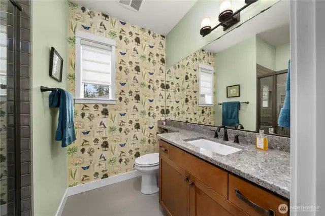 Guest bathroom with Quartz counters, oil rubber bronze fixtures and designer wallpaper.