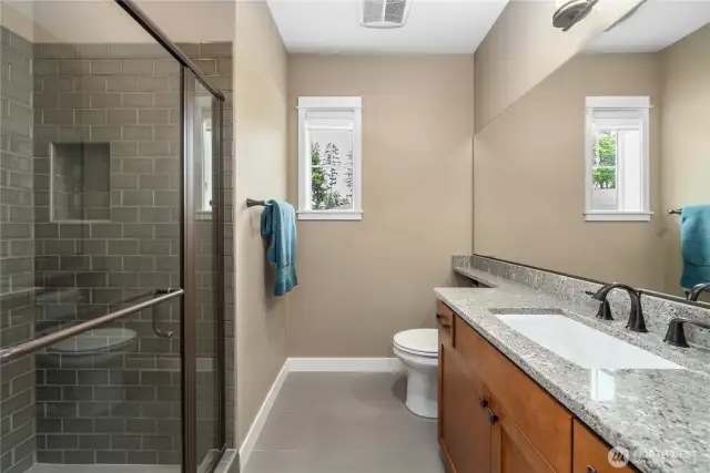 Guest bathroom with Quartz counters, tiled floor & shower, oil rubber bronze fixtures w/ upgraded (thicker) glass shower door.