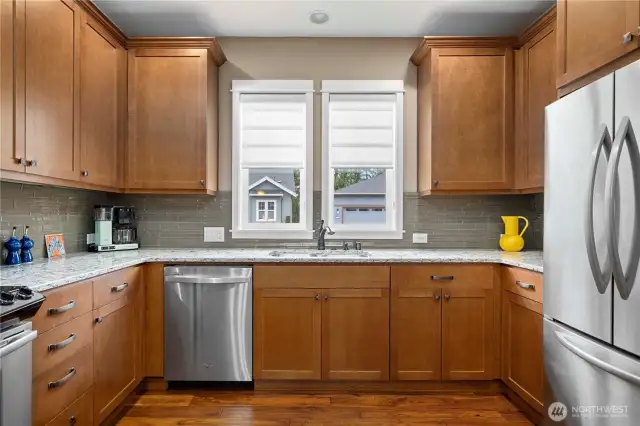 Window above the sink and custom window coverings. Top tier appliances.
